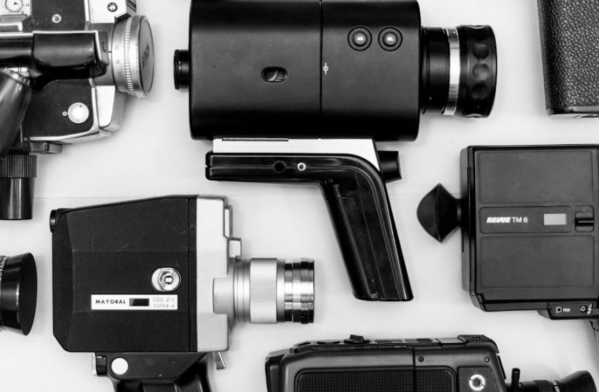 Flat lay of assorted vintage video cameras in black and white photography.