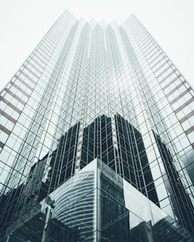 Striking low angle view of a modern skyscraper with reflective glass facade in a cityscape